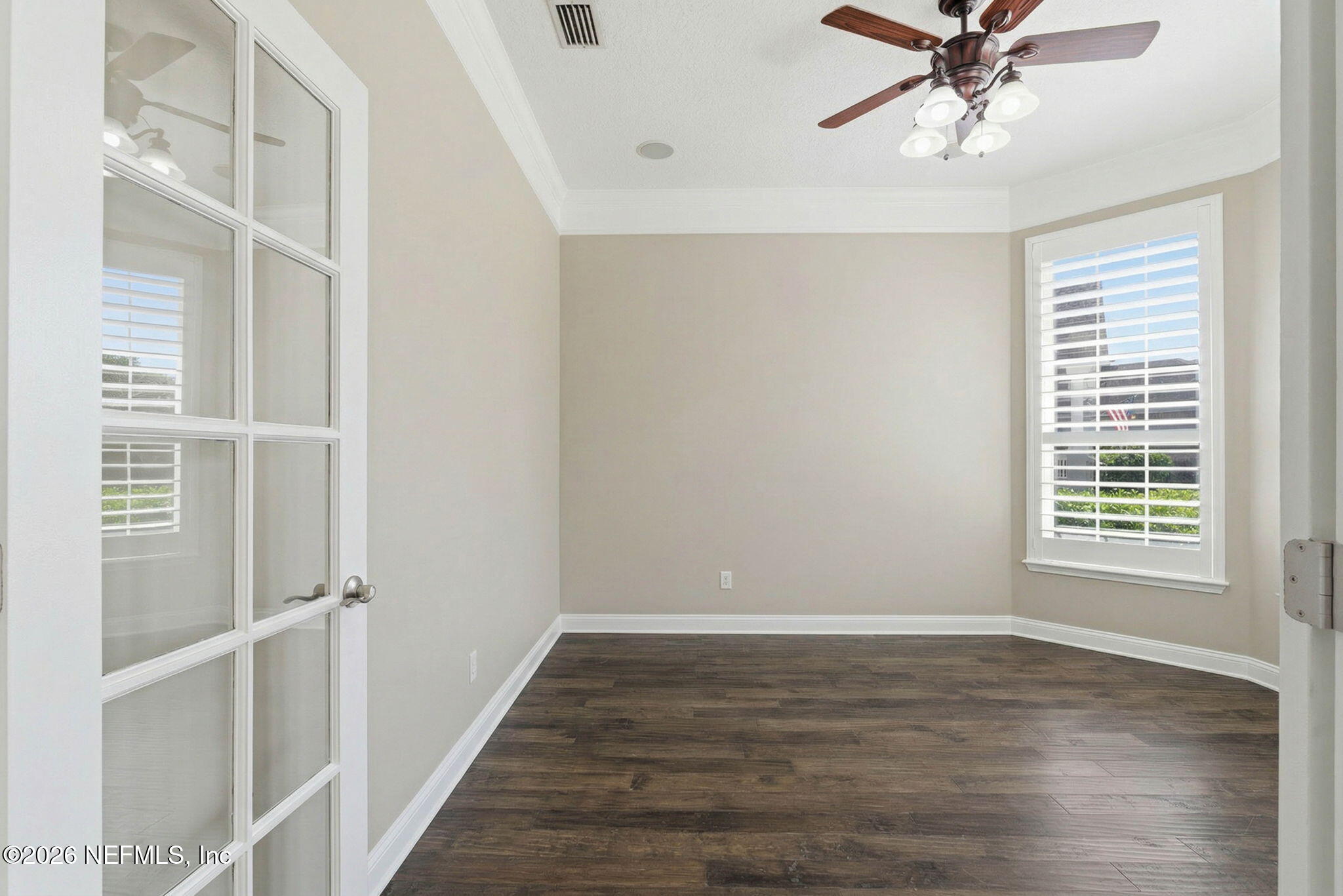 1600 Spring Water Court Fleming Island, FL 32003 - Photo 12 of 85 a view of an empty room with wooden floor and a window