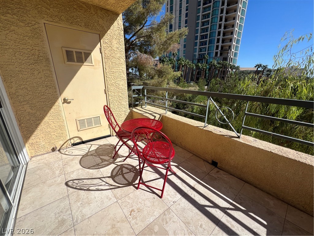 270 East Flamingo Road, Unit 313 Las Vegas, NV 89169 - Photo 18 of 27 City views and tiled floors define this inviting outdoor space.