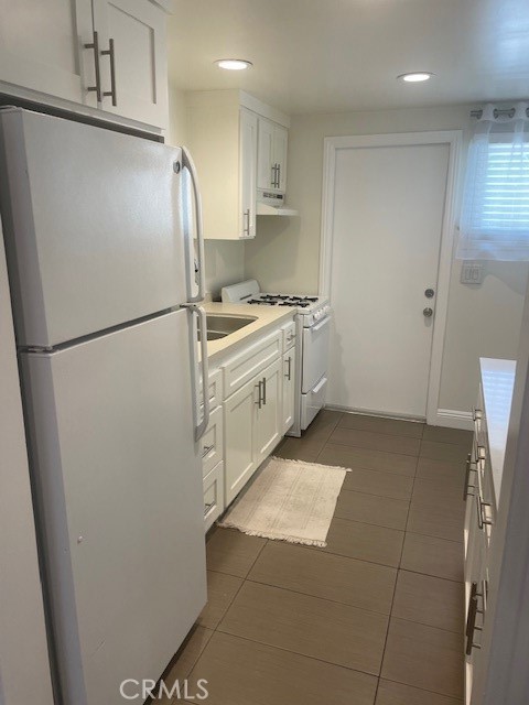 2023 Lovila Lane Altadena, CA 91001 - Photo 9 of 14 a kitchen with a refrigerator sink stove and cabinets