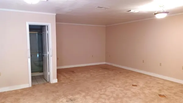 an empty room with a empty space and windows