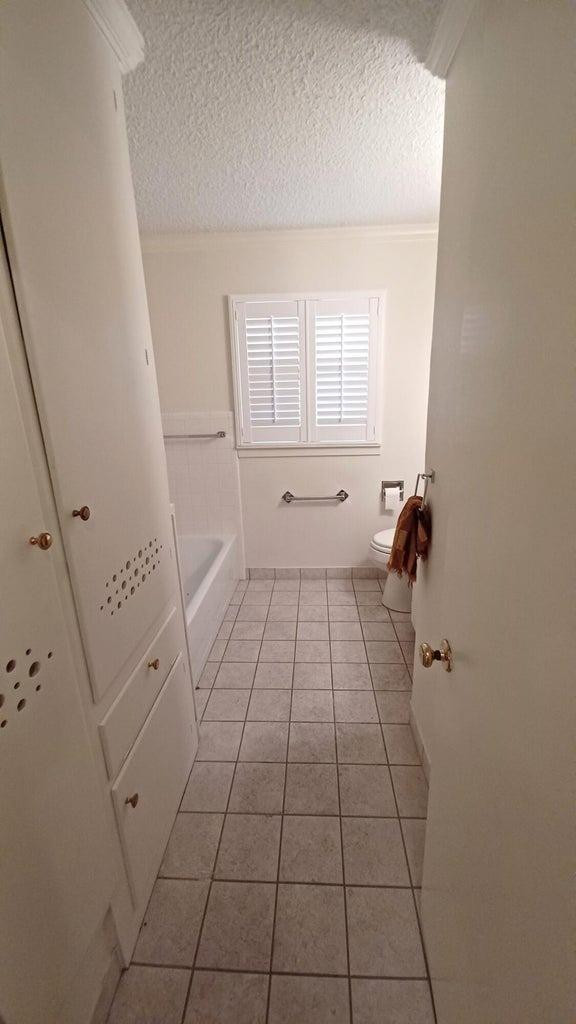 206 South W 7th Street Lockney, TX 79241 - Photo 27 of 47 a bathroom with a sink a toilet and a window
