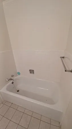 a bathroom with a bathtub and shower