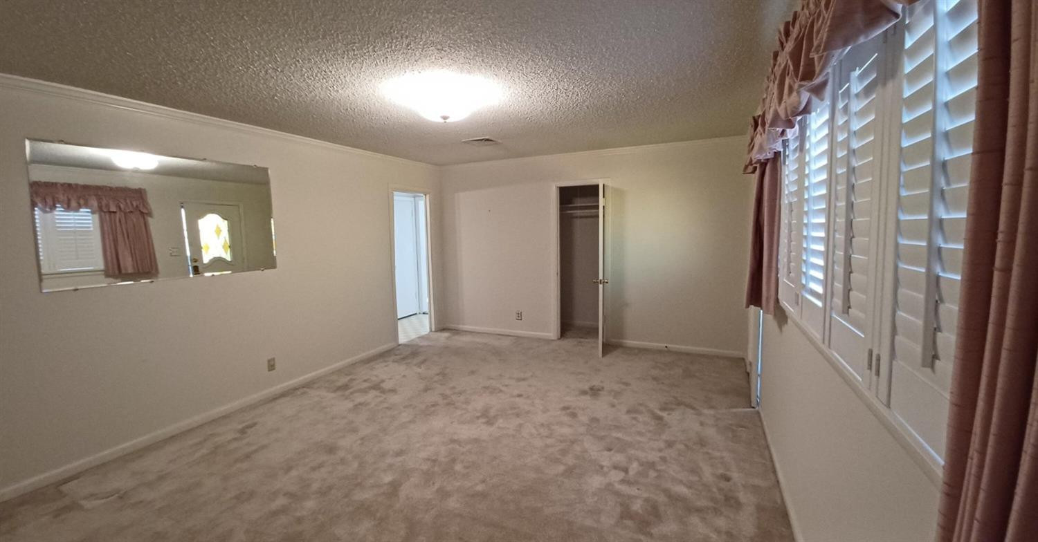 206 South W 7th Street Lockney, TX 79241 - Photo 6 of 47 en empty room with windows