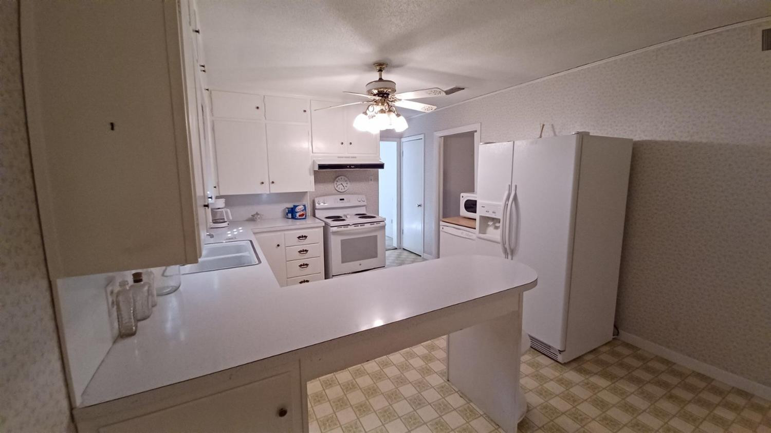 206 South W 7th Street Lockney, TX 79241 - Photo 10 of 47 a kitchen with stainless steel appliances a refrigerator sink and stove