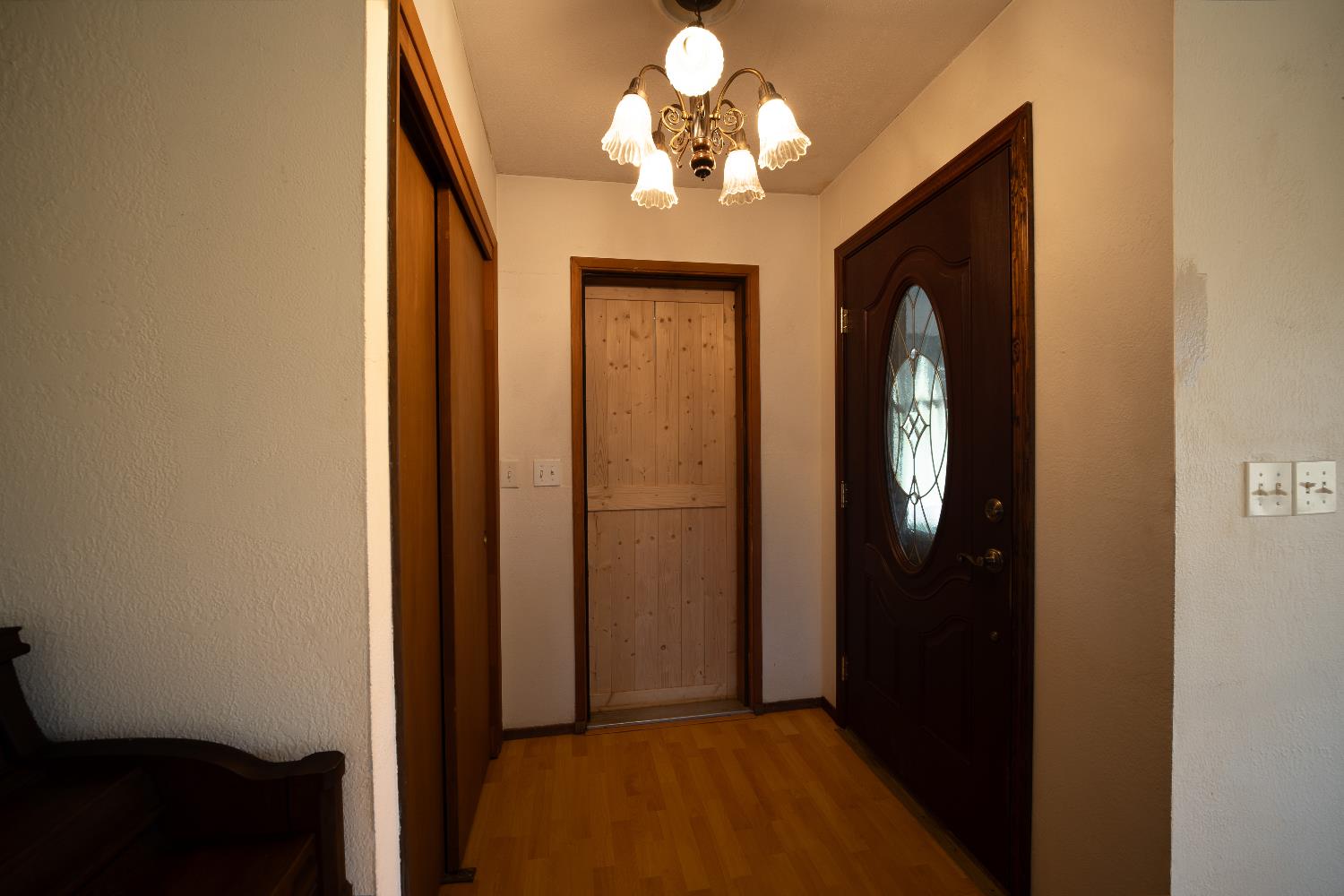 33 Stanley Road West Point, CA 95255 - Photo 18 of 46 a view of a hallway with wooden floor and a chandelier