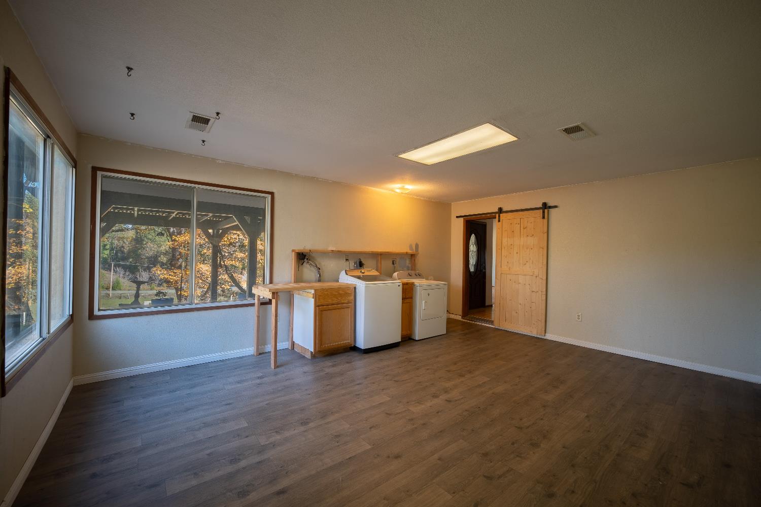 33 Stanley Road West Point, CA 95255 - Photo 28 of 51 a view of an empty room with a window and wooden floor