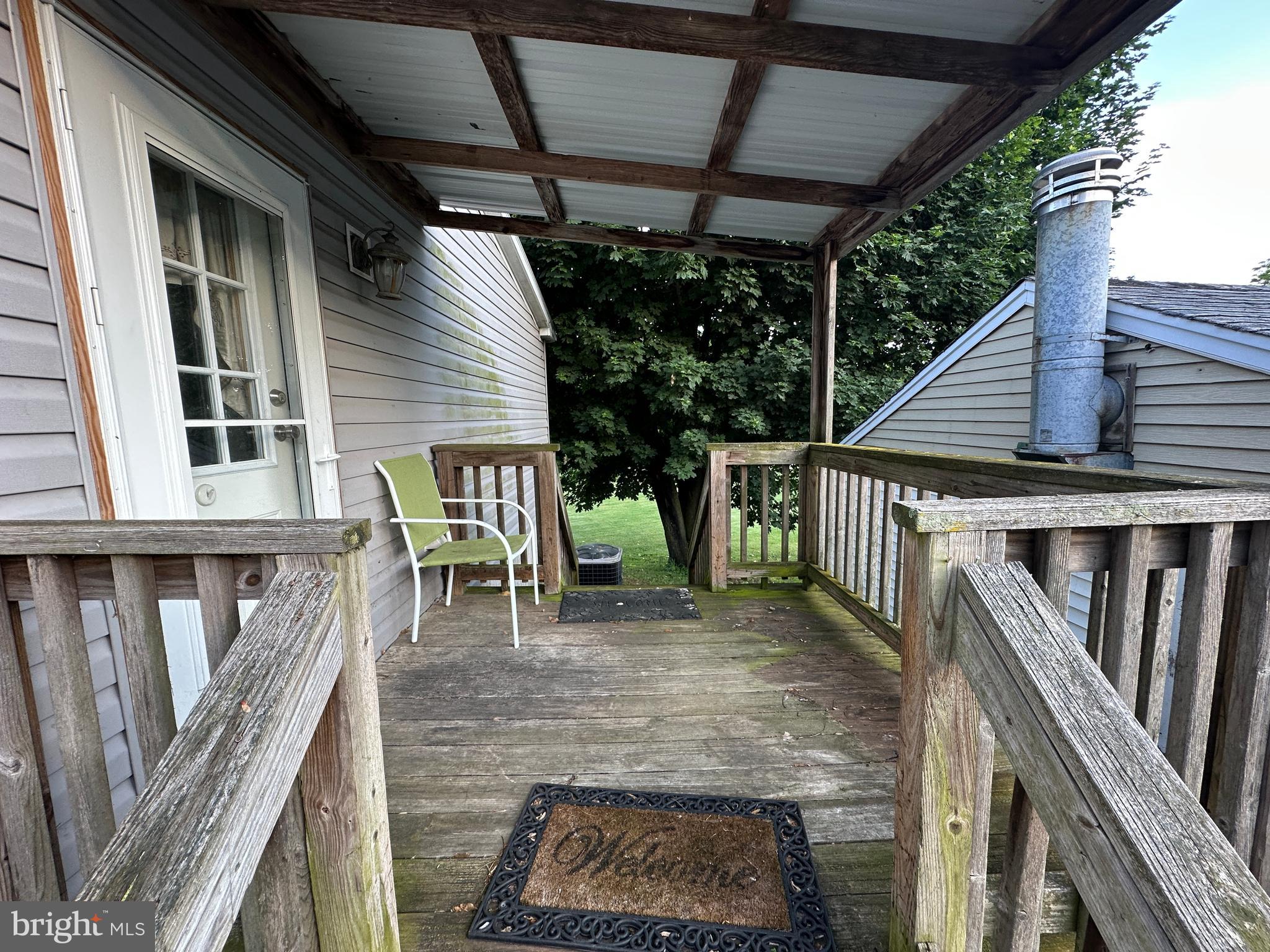 4391 Cito Road McConnellsburg, PA 17233 - Photo 6 of 67 a view of deck with wooden chairs and floor to ceiling window with wooden fence