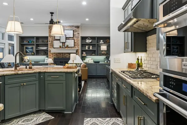 a kitchen with a sink stove and cabinets