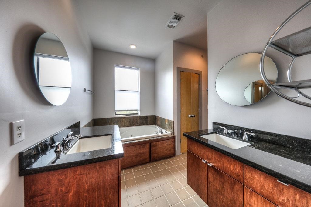 2310 Union Street, Unit A Houston, TX 77007 - Photo 14 of 16 a bathroom with a double vanity sink and a mirror