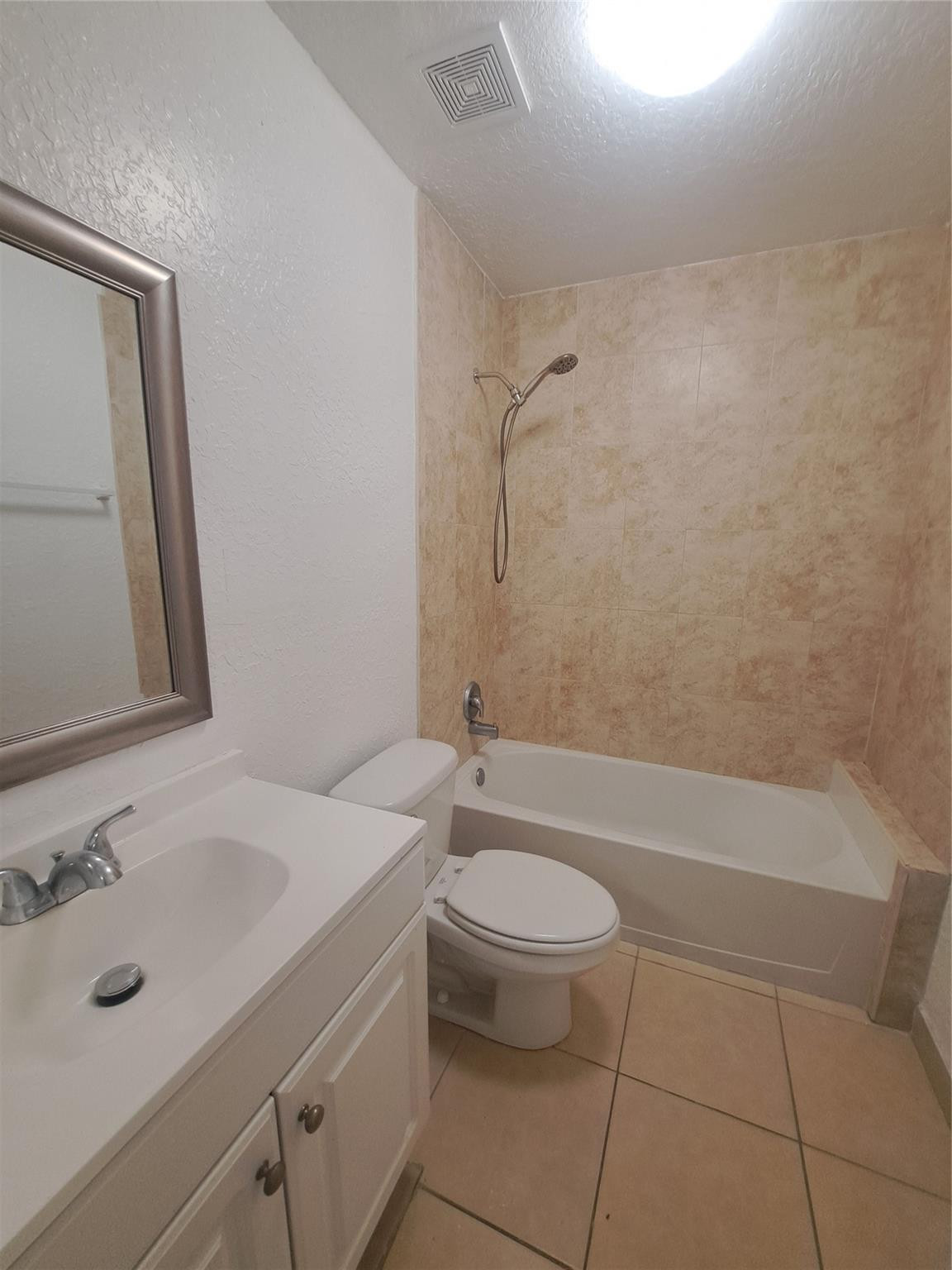 2851 Riverside Drive, Unit 407 Coral Springs, FL 33065 - Photo 4 of 10 a bathroom with a sink a toilet and bathtub