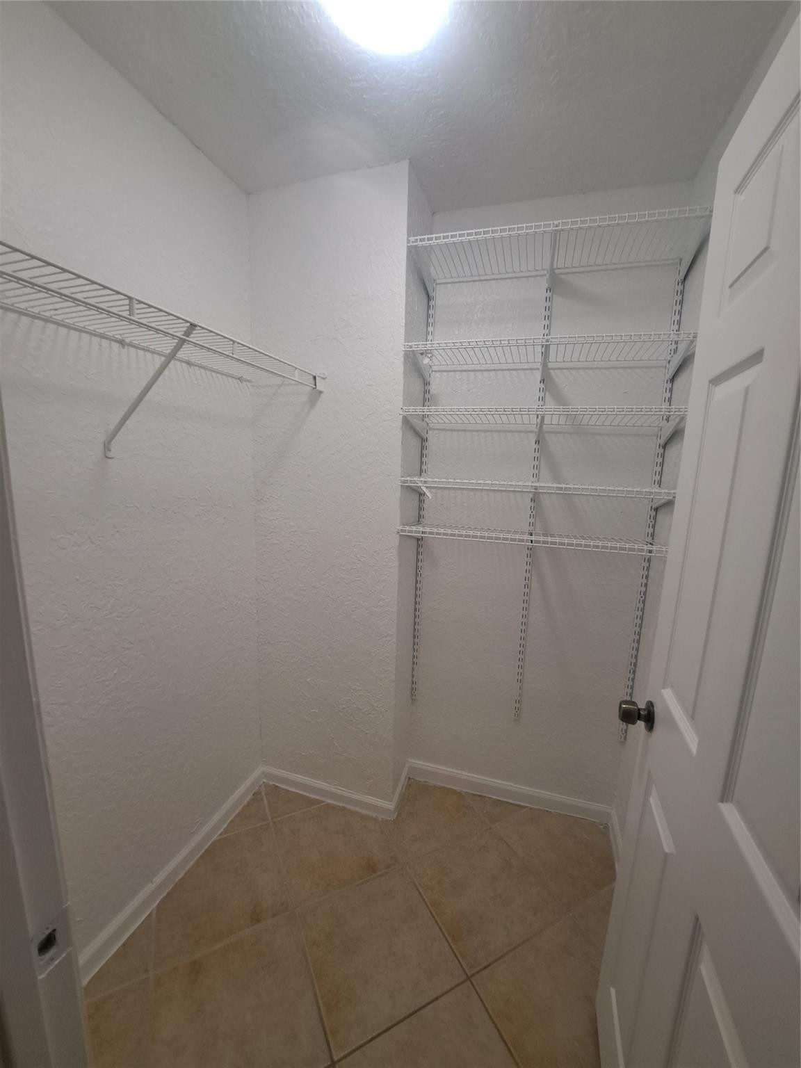 2851 Riverside Drive, Unit 407 Coral Springs, FL 33065 - Photo 8 of 10 a view of a room with racks on the wall
