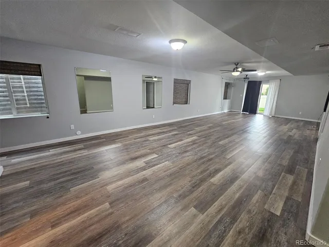 a view of a livingroom with wooden floor and window