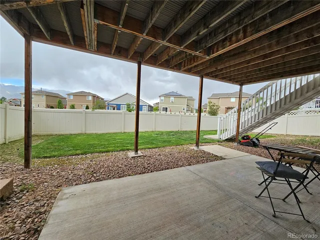 a view of a porch with a table and chairs