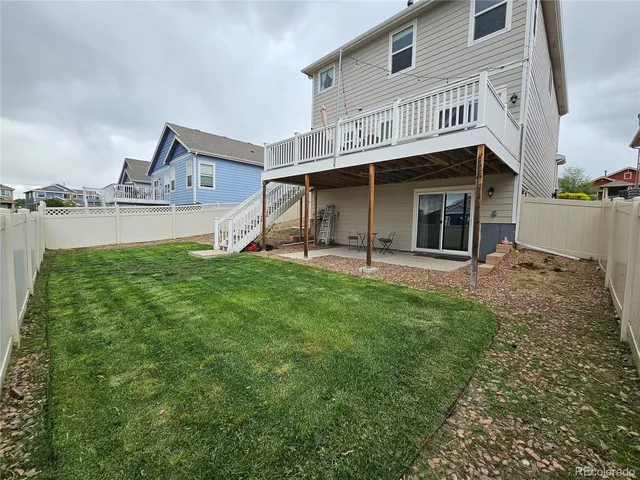 a view of a house with yard and sitting area