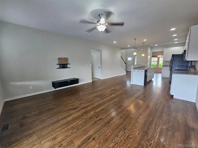 a view of kitchen and hall with wooden floor