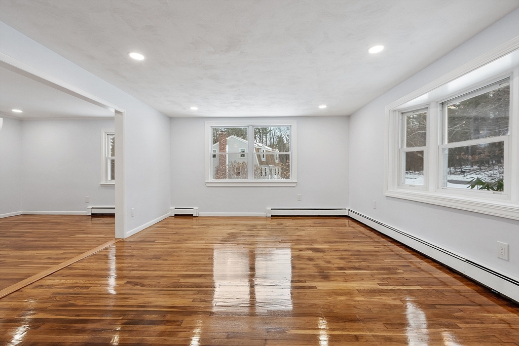 10 Townsend Road Shirley, MA 01464 - Photo 17 of 38 a view of an empty room with wooden floor and a window
