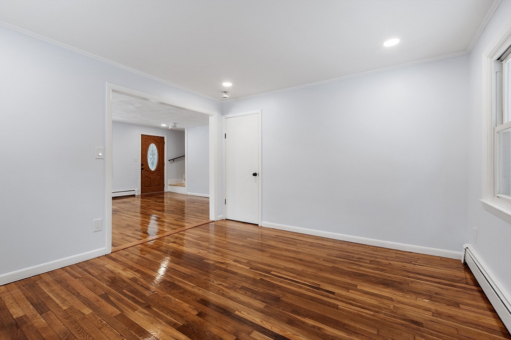 10 Townsend Road Shirley, MA 01464 - Photo 21 of 38 a view of an empty room with wooden floor and a window
