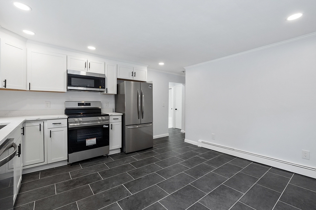 10 Townsend Road Shirley, MA 01464 - Photo 6 of 38 a kitchen with a refrigerator a stove top oven and cabinets