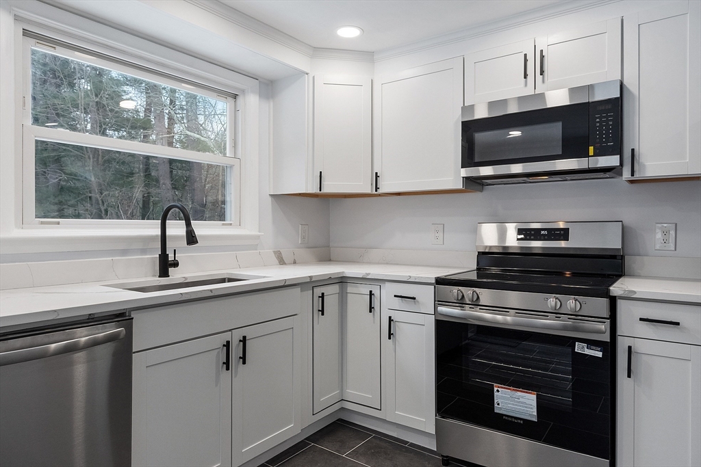 10 Townsend Road Shirley, MA 01464 - Photo 7 of 38 a kitchen with cabinets stainless steel appliances and a sink