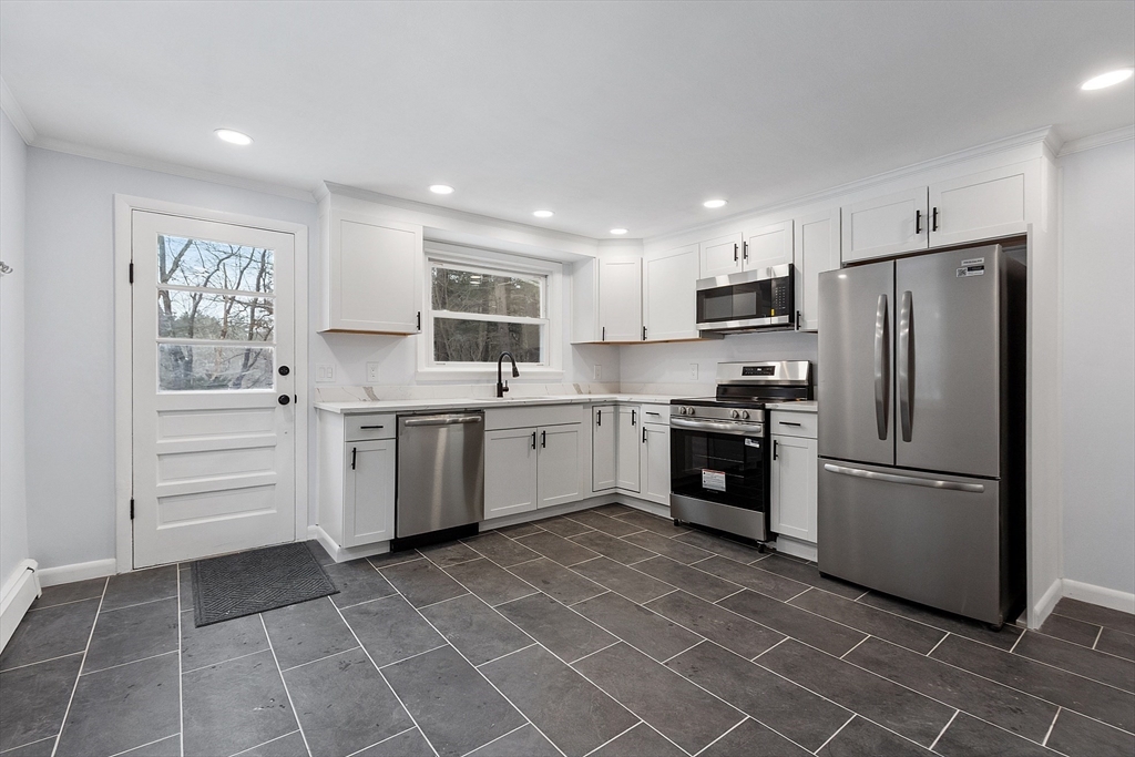 10 Townsend Road Shirley, MA 01464 - Photo 8 of 38 a kitchen with a white cabinets and white stainless steel appliances