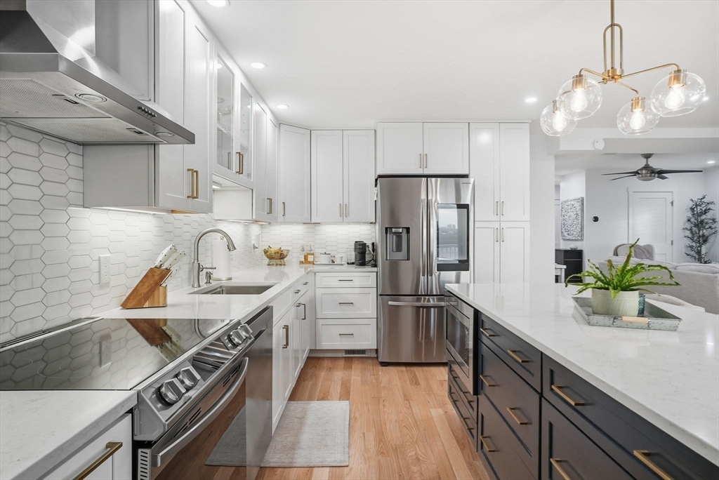191 Court Road, Unit 3 Winthrop, MA 02152 - Photo 3 of 23 a kitchen with stainless steel appliances a sink stove and refrigerator