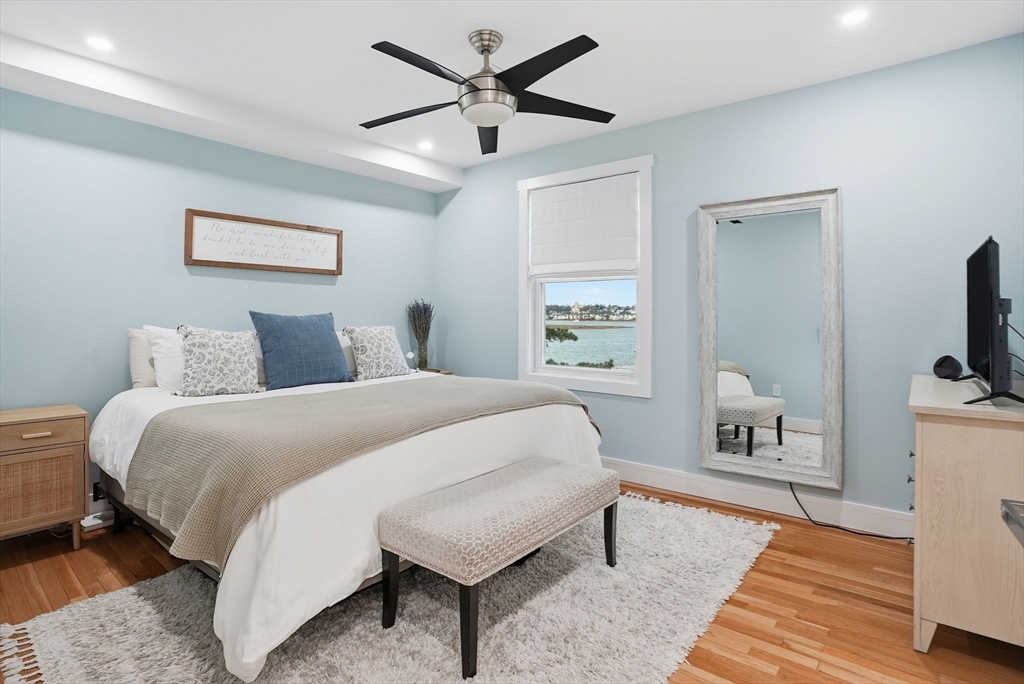 191 Court Road, Unit 3 Winthrop, MA 02152 - Photo 7 of 23 a bedroom with a bed and a flat tv screen on dresser