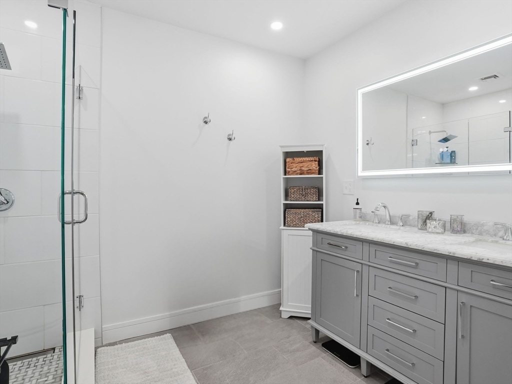 191 Court Road, Unit 3 Winthrop, MA 02152 - Photo 10 of 23 a bathroom with a granite countertop sink and a mirror
