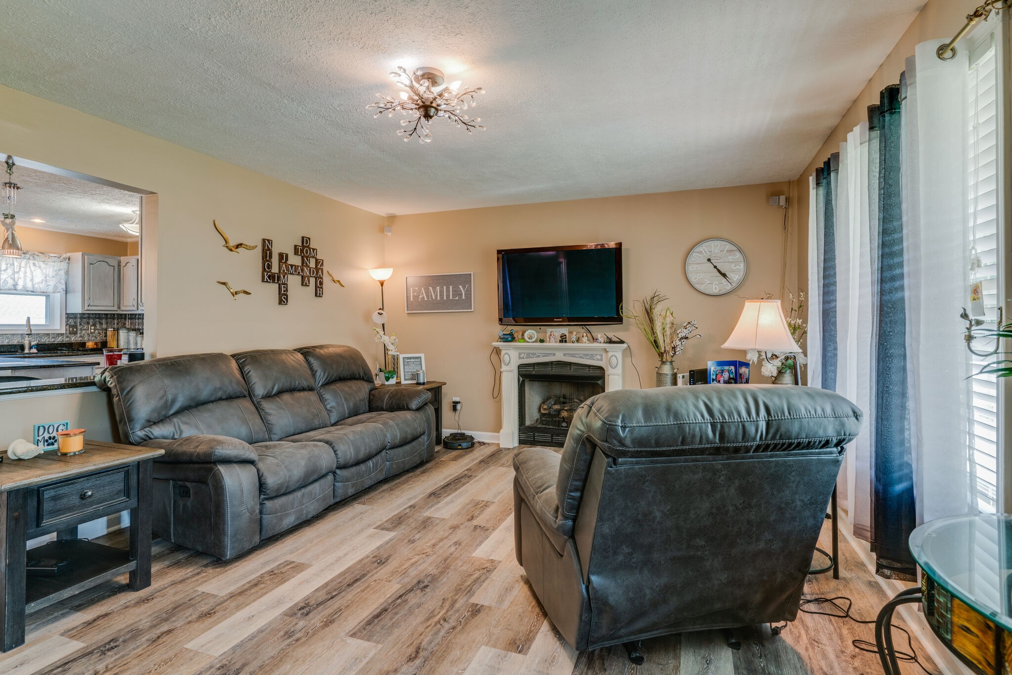 2755 Gideon Road Greenbrier, TN 37073 - Photo 4 of 30 a living room with furniture a flat screen tv and a fireplace
