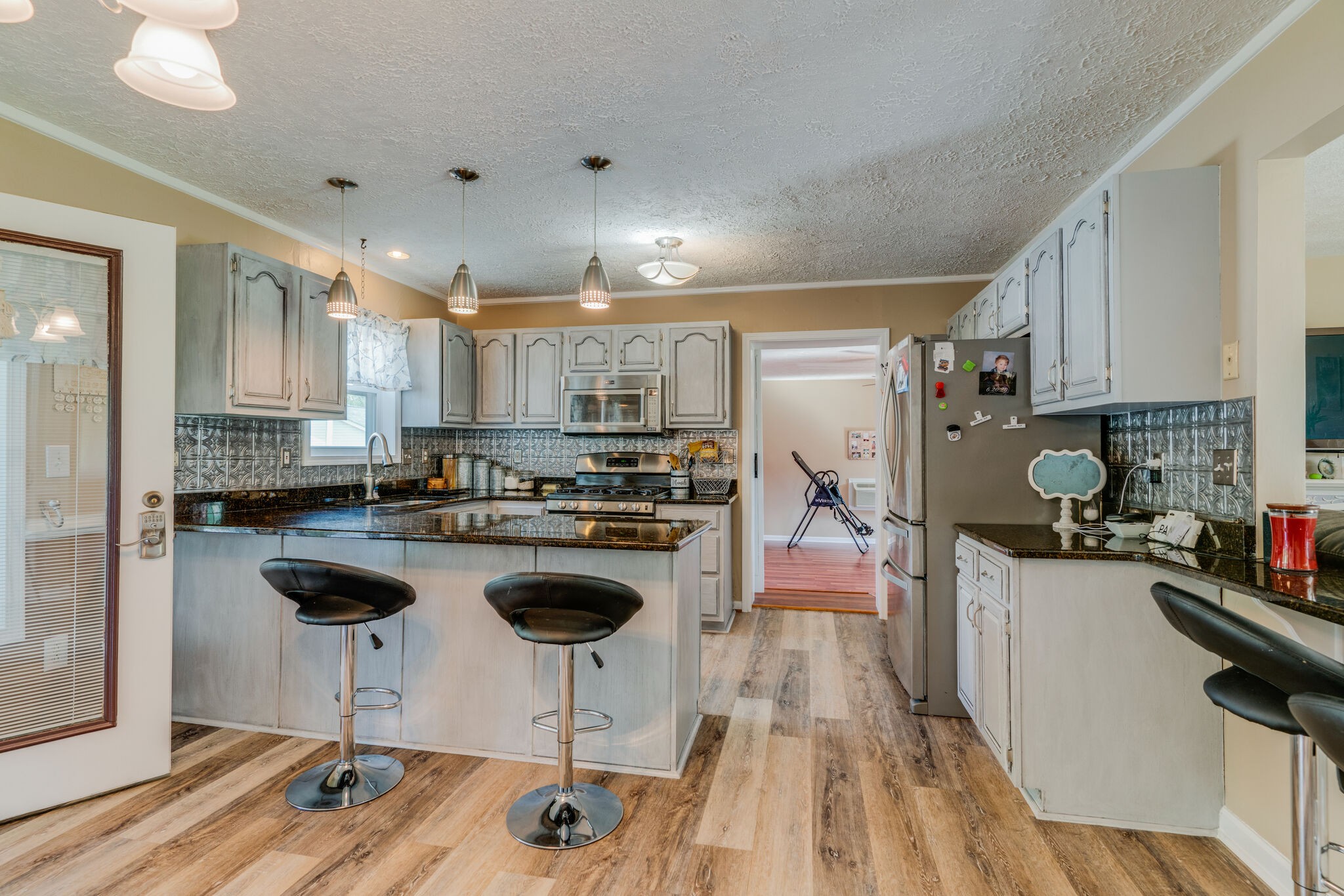 2755 Gideon Road Greenbrier, TN 37073 - Photo 7 of 30 a kitchen with kitchen island granite countertop a sink cabinets and stainless steel appliances