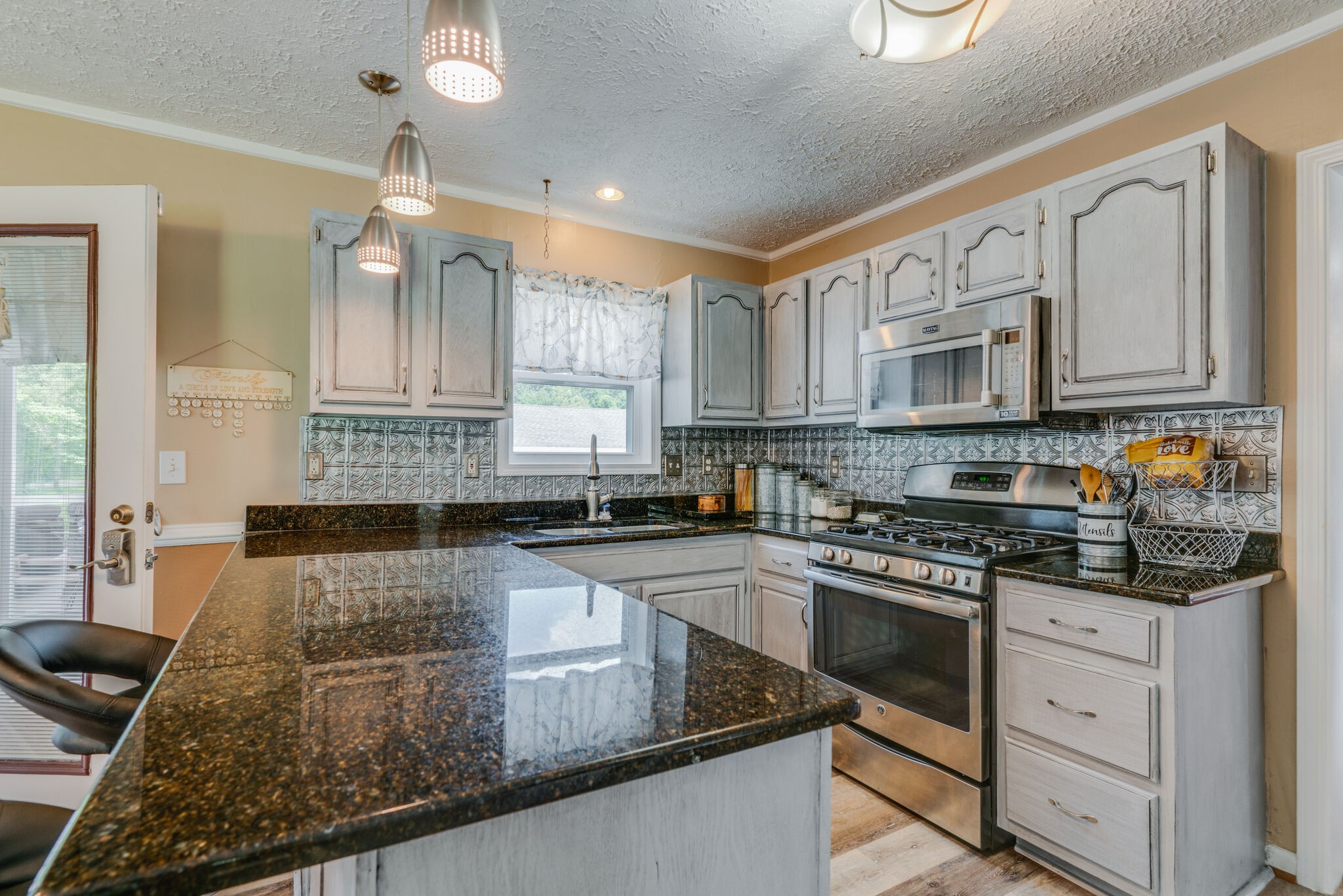 2755 Gideon Road Greenbrier, TN 37073 - Photo 8 of 30 a kitchen with stainless steel appliances granite countertop a stove a sink dishwasher and cabinets with wooden floor