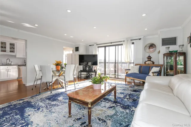a living room with furniture a flat screen tv and a table