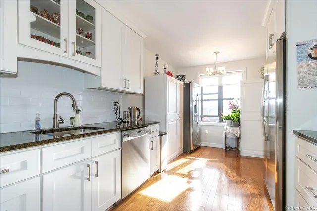 a kitchen with stainless steel appliances a refrigerator sink and cabinets