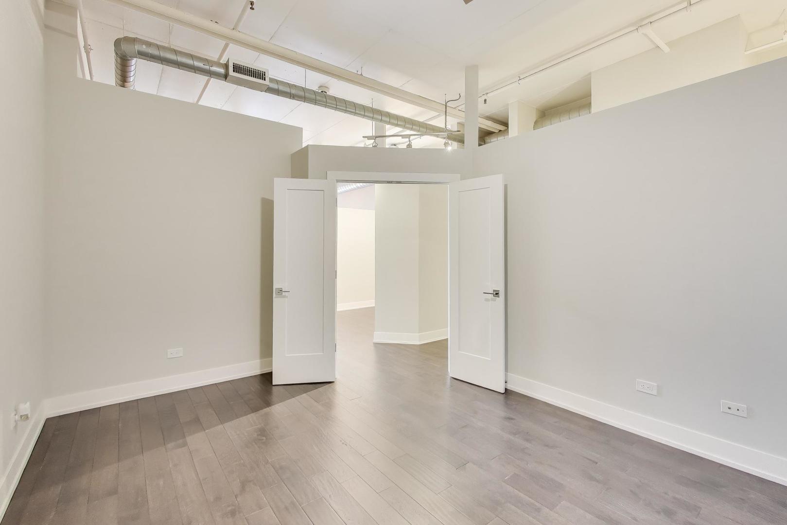 1301 West Madison Street, Unit 315 Chicago, IL 60607 - Photo 12 of 27 a view of walk in closet with wooden floor