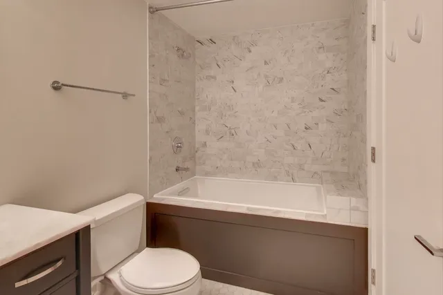 a bathroom with a bathtub and toilet