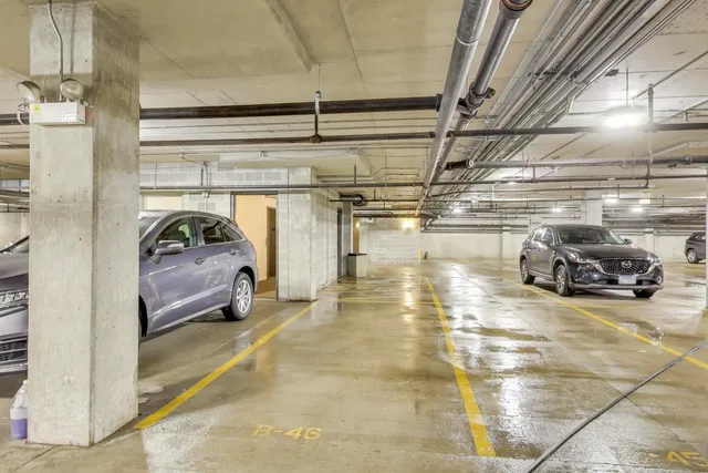 a view of parking garage with cars