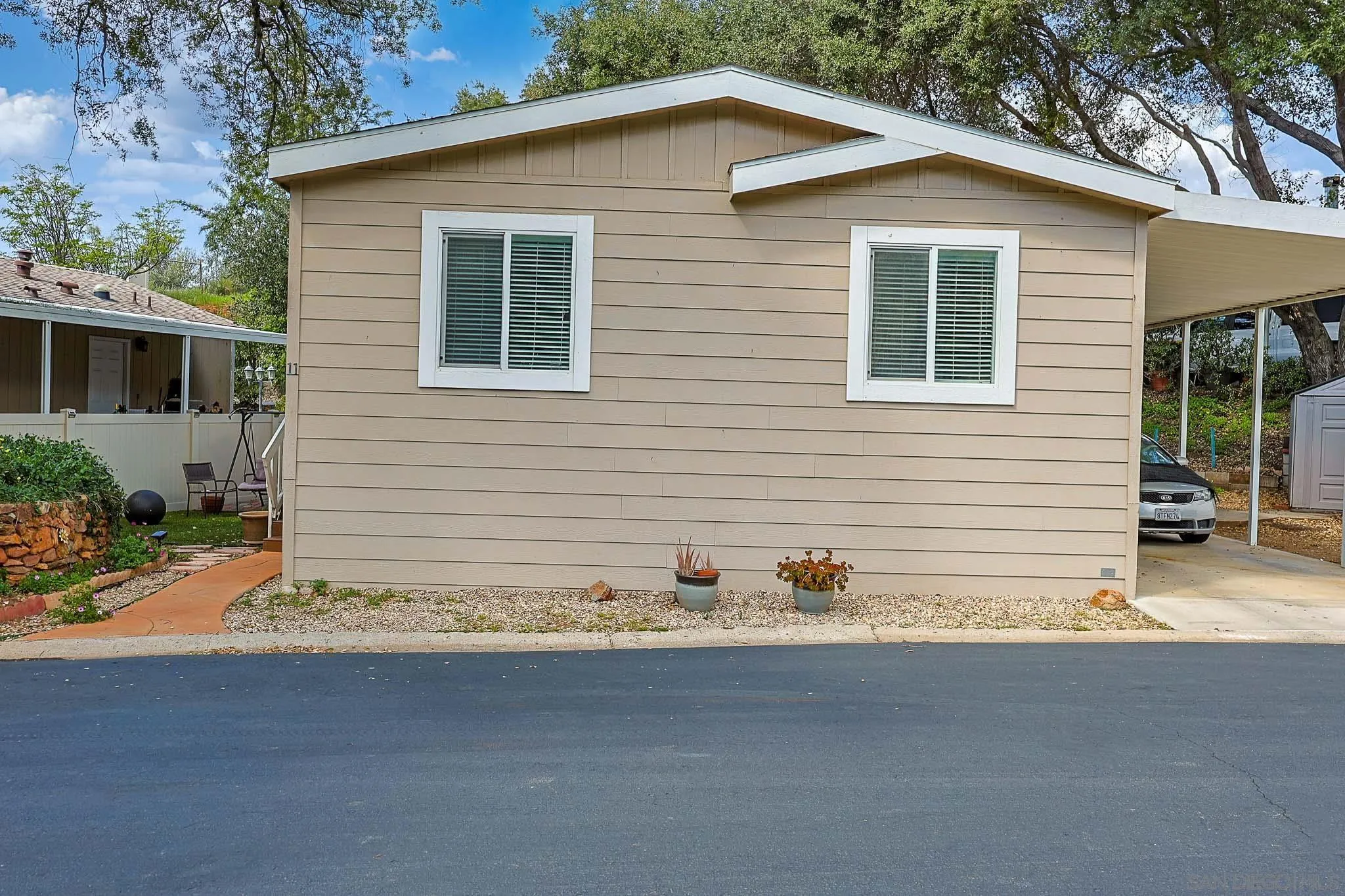 3505 Alpine Boulevard, Unit SPC 11 Alpine, CA 91901 - Photo 29 of 43 a view of a house with a yard and garage