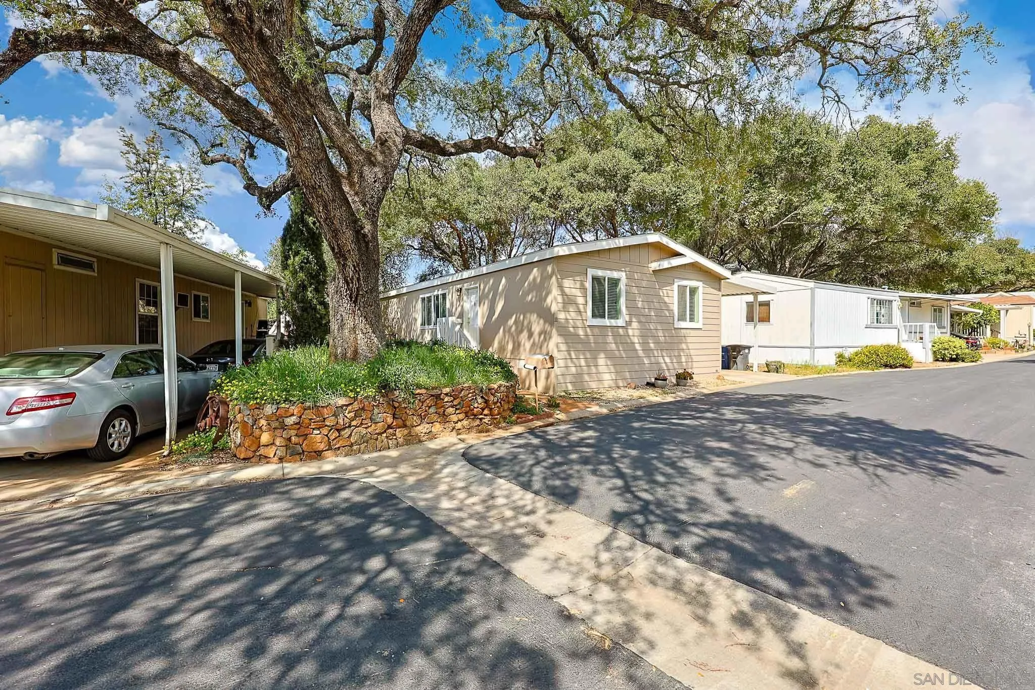 3505 Alpine Boulevard, Unit SPC 11 Alpine, CA 91901 - Photo 31 of 43 a white house that has a tree in front of it
