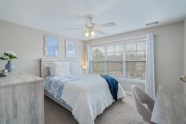 a bedroom with a bed and a table