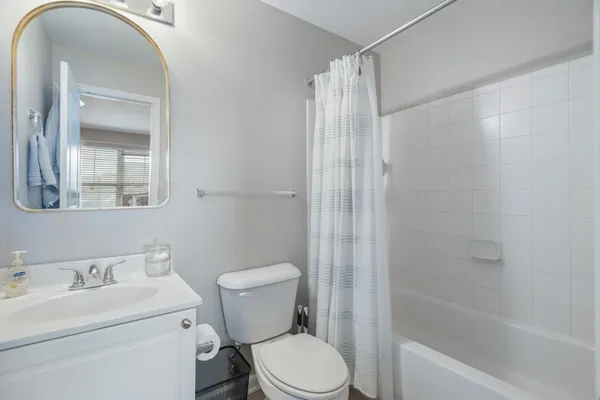 a bath room with a toilet a sink and a bath tub