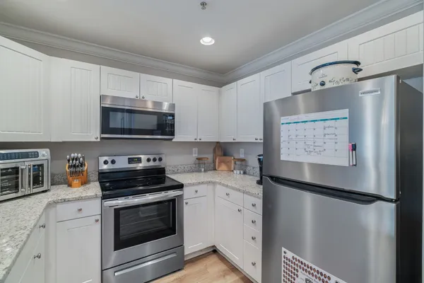 a kitchen with stainless steel appliances a refrigerator sink and microwave