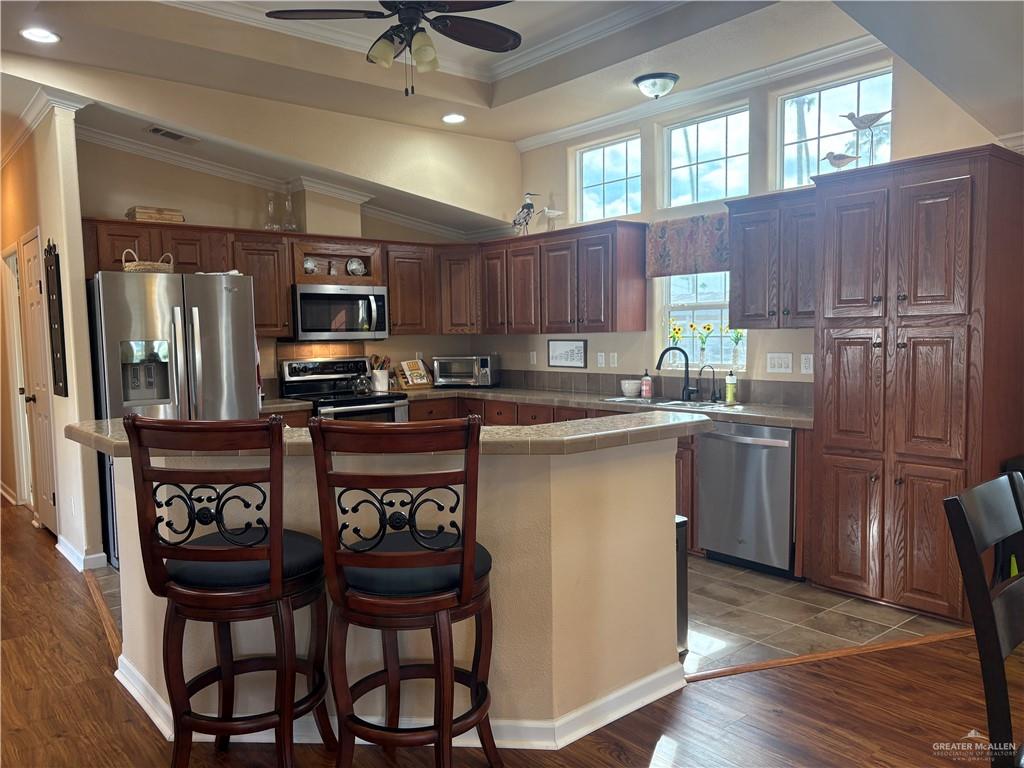 3078 Durango Street Mercedes, TX 78570 - Photo 14 of 41 a kitchen with a table chairs refrigerator and microwave
