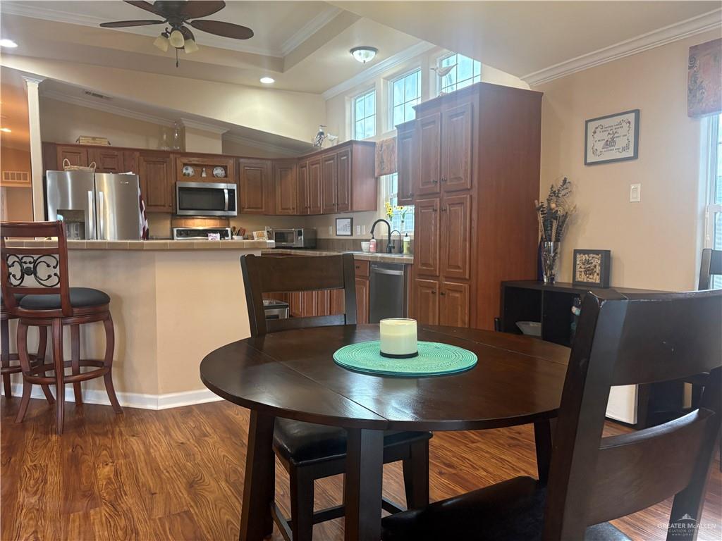 3078 Durango Street Mercedes, TX 78570 - Photo 15 of 41 a view of a dining room with furniture and wooden floor