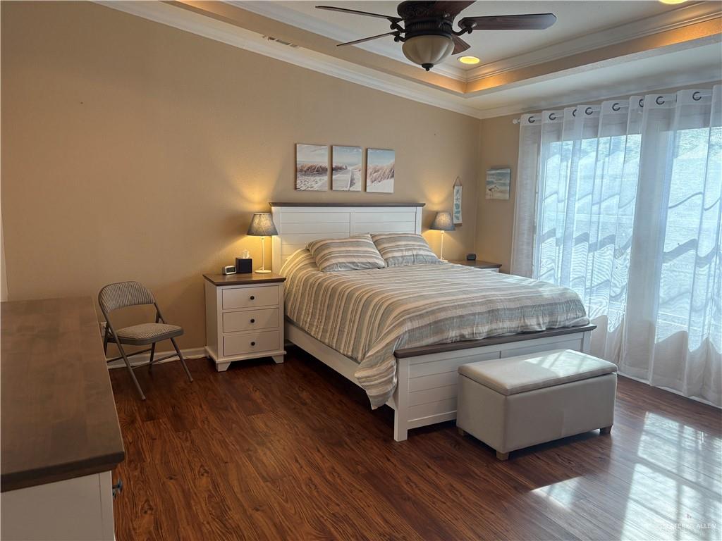 3078 Durango Street Mercedes, TX 78570 - Photo 19 of 41 a bedroom with a bed and a chandelier