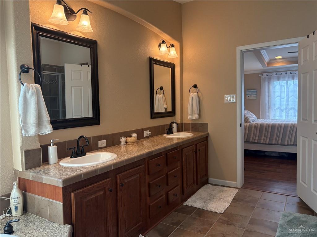 3078 Durango Street Mercedes, TX 78570 - Photo 25 of 41 a en suite bathroom with a double vanity sink and a mirror