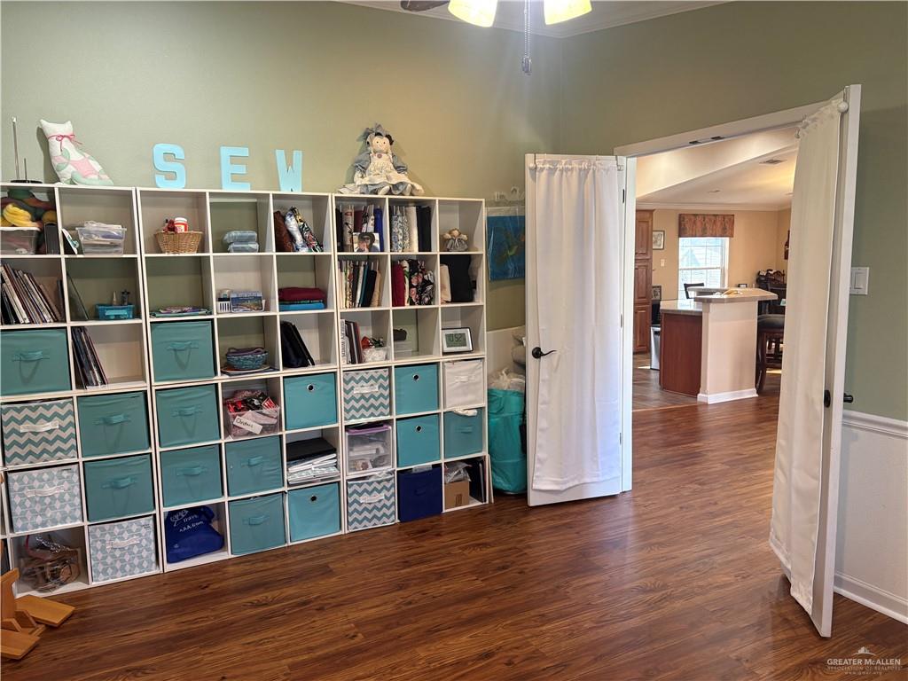 3078 Durango Street Mercedes, TX 78570 - Photo 33 of 41 a view of a living room with wooden floor and a cabinet
