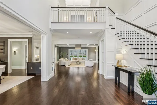 a living room with furniture a chandelier and a large window
