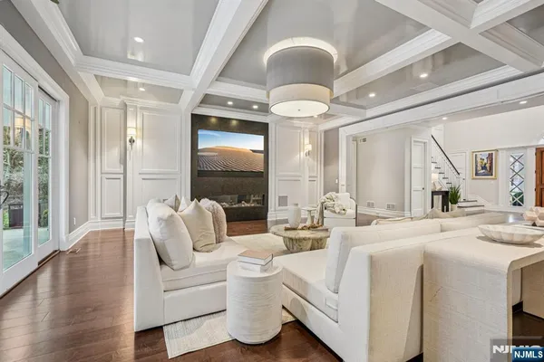 a spacious bedroom with a large bed and a flat screen tv