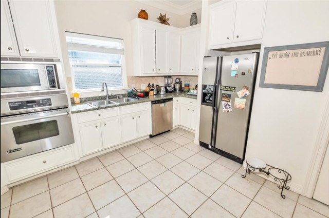 3011 Houston Avenue, Unit B Houston, TX 77009 - Photo 12 of 24 a kitchen with a refrigerator sink and cabinets