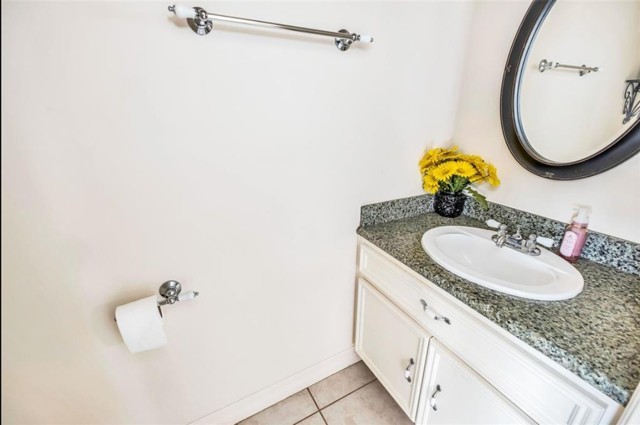 3011 Houston Avenue, Unit B Houston, TX 77009 - Photo 16 of 24 a bathroom with a granite countertop sink and a mirror