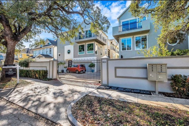 3011 Houston Avenue, Unit B Houston, TX 77009 - Photo 2 of 24 a front view of a house with a yard and a large tree